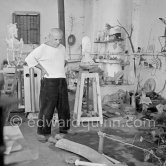 Pablo Picasso working in his sculpture studio Le Fournas making a sculpture figure with odds and ends from his scrap heap. Here he is adding a branch to the sculpture which was later replaced by a key. The finished sculpture got the name "La femme à la clé (La Taulière)" ("Woman with a key"). Le Fournas, Vallauris 1953. - Photo by Edward Quinn