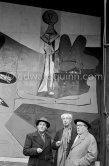From left Paul Derigon, the mayor of Vallauris, Georges Salles, President of the ICOM (left) and Henri Laugier, Member of the Executive committee of the UNESCO. Unveiling of mural "The Fall of Icarus" ("La chute d'Icare") for the conference hall of UNESCO building in Paris. The mural is made up of forty wooden panels. Initially titled "The Forces of Life and the Spirit Triumphing over Evil", the composition was renamed in 1958 by George Salles, who preferred the current title, "The Fall of Icarus" ("La chute d'Icare"). Vallauris, 29 March 1958. - Photo by Edward Quinn