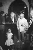 Pablo Picasso and Jacques Prévert. On the left in the background Jacqueline. he girl is Yoyo Maeght, the grandchild of Aimé Maeght. Opening of the exhibition "Images de Jacques Prévert", Château Grimaldi, Antibes, 6.8.1963. - Photo by Edward Quinn