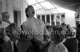 Esther Williams singing during a lunch at the Cannes Film Festival (in the foreground Doris Day and actor Van Johnson), Cannes, France 1955. - Photo by Edward Quinn
