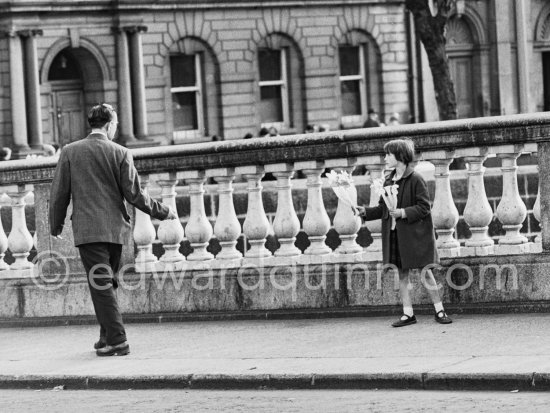 St. Patrick’s Day: Flower seller on O\'Donovan Rossa Bridge. Dublin 1963. - Photo by Edward Quinn