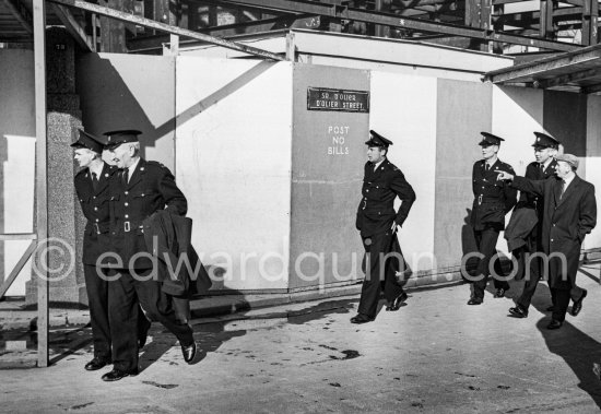 Policemen walking through D'Olier Street. Dublin 1963. Published in Quinn, Edward. James Joyces Dublin. Secker & Warburg, London 1974. - Photo by Edward Quinn