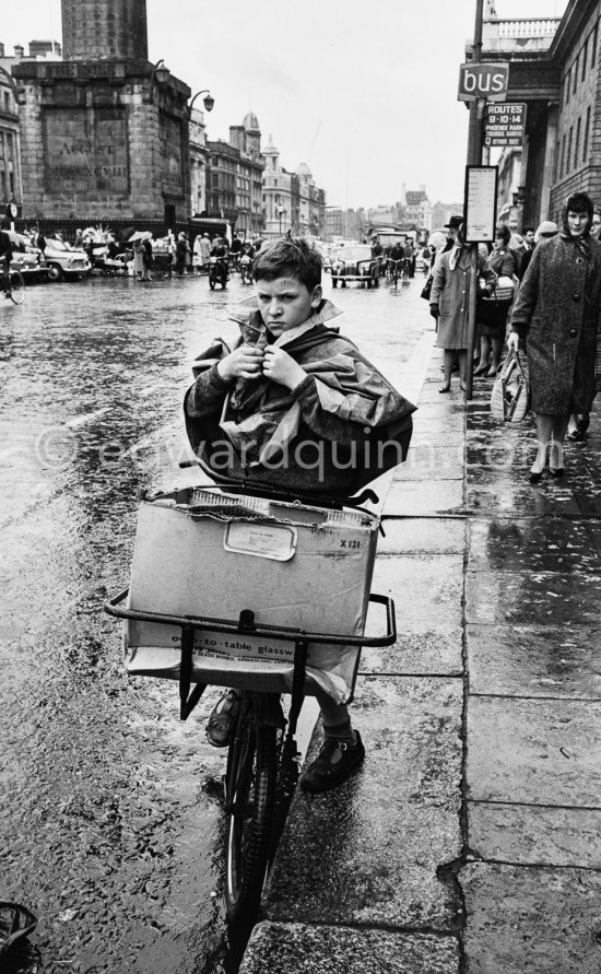 Bicycle courier. O\'Connell Street, Nelson Pillar. Dublin 1963. - Photo by Edward Quinn