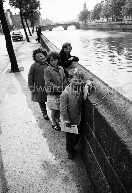 Children at the River Liffey. Father Mathew Bridge, St Paul\'s Church on the other side. Dublin 1963.n Dublin 1963. - Photo by Edward Quinn