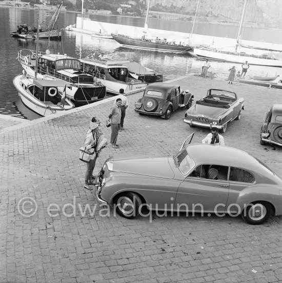 Gianni Agnelli and his Bentley. Since his bad accident with his Ferrari in 1952, he had to walk with a stick. Beaulieu 1954. Cars: 11952 Bentley R-Type Continental, #BC12A, 2-Door Fastback Saloon by H.J.Mulliner (Detailed info on this car by expert Klaus-Josef Rossfeldt see About/Additional Infos), and from left 1949 Citroën Traction Avant 11 BL with special bumper; 1951 Studebaker Champion Regal convertible; about 1950 Citroën Traction Avant 11 BL - Photo by Edward Quinn