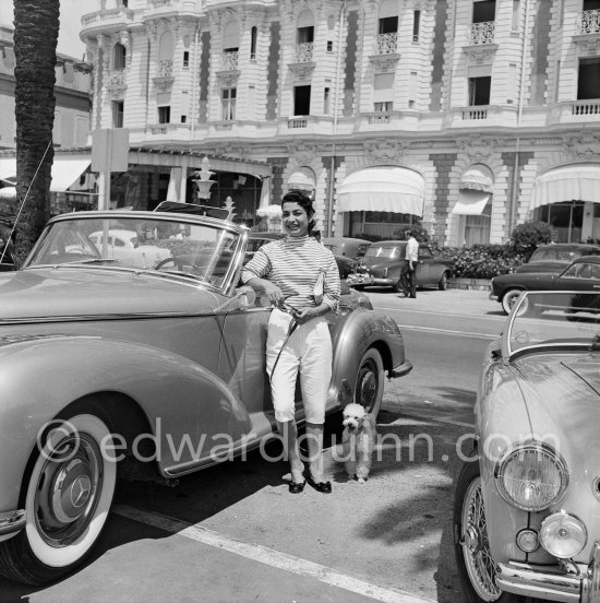 Princess Ashraf, sister of the Shah of Persia, blouse and wallet matching, posing in front of Carlton Hotel with her poodle. Cannes 1953. Car: 1951-58 Mercedes-Benz 300 S Roadster - Photo by Edward Quinn