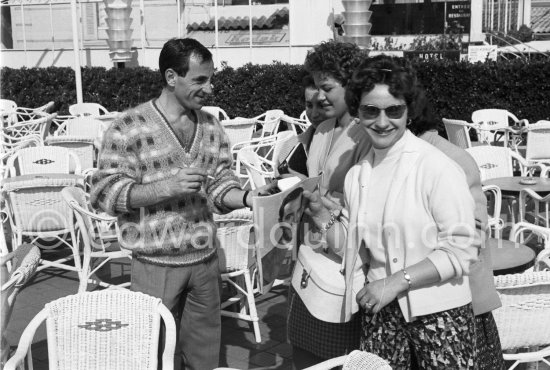 Charles Aznavour signing autographs outside the Carlton Hotel. Cannes 1959. - Photo by Edward Quinn