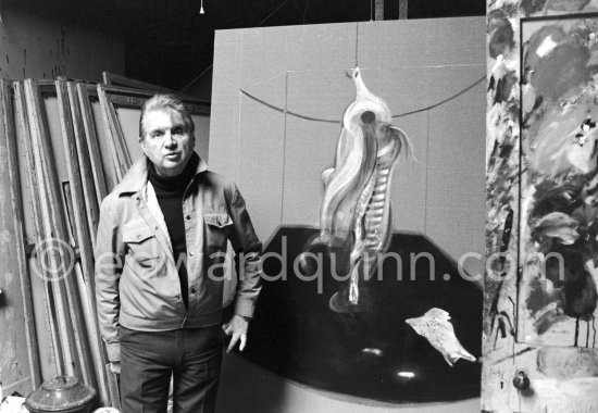 Francis Bacon with the painting "Carcass of Meat and Bird of Prey" at his Reece Mews studio in London 1980. - Photo by Edward Quinn