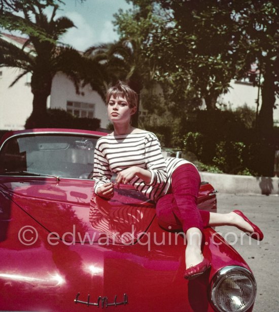 Brigitte Bardot with Repetto ballerinas, Capri trousers and a Breton shirt posing ever so nicely on a Simca Aronde Week-end during Cannes Film Festival 1956. - Photo by Edward Quinn