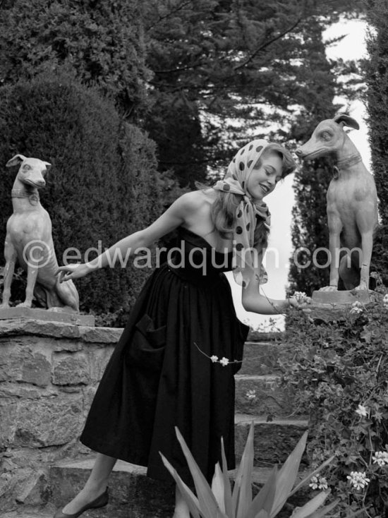 Brigitte Bardot posing with dog sculpture. Cannes Film Festival 1953. - Photo by Edward Quinn