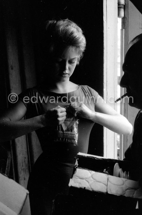 Brigitte Bardot, opening a snack, at the Studios de la Victorine, during filming of "Et Dieu créa la femme". Nice 1956. - Photo by Edward Quinn