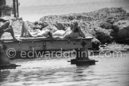 Brigitte Bardot (right) pictured sun bathing near her home on Saint-Tropez in 1961. - Photo by Edward Quinn