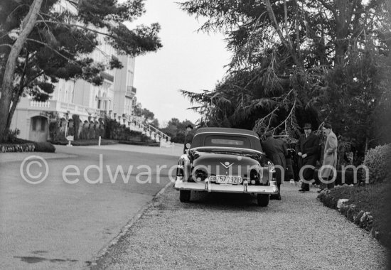 King Baudouin of Belgium, far right, with Mr. Weemaes, secretary of his father, ex-King Leopold, in the garden of Hotel du Cap d\'Antibes 1952. Car: 1950 Cadillac Series 62 Style 6267 convertible coupé - Photo by Edward Quinn