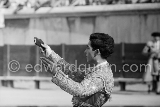 The price for a brilliant performance, a bull's ear. Paco Camino holds it up victoriously in answer to the crowd's cheers. Paco Camino is only 18 years old. Nimes 1960. A bullfight Picasso attended (see "Picasso"). - Photo by Edward Quinn