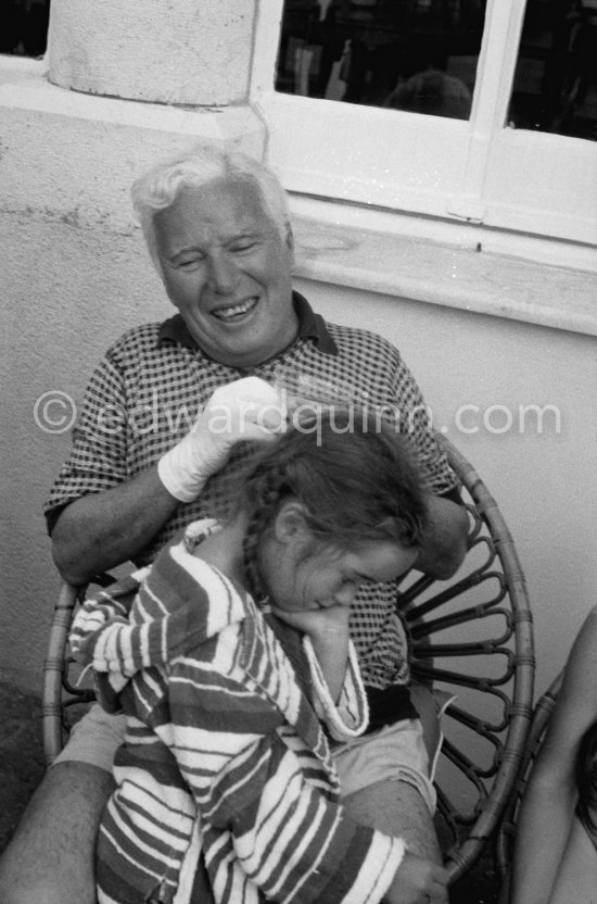 Charlie Chaplin with his daughter Josephine interviewed for a radio station. When asked why he was wearing white gloves, he said it wasn't coquetry, but a slight case of eczema. Villa Lo Scoglietto, Saint-Jean-Cap-Ferrat, 1956. - Photo by Edward Quinn