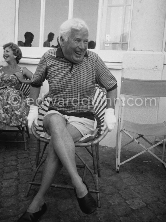Charlie Chaplin at the Villa Lo Scoglietto. He was in Cannes to talk to the press about his latest film, "A King in New York", due to be premiered in London. When asked why he was wearing white gloves, he said it wasn't coquetry, but a slight case of eczema. Villa Lo Scoglietto, Saint-Jean-Cap-Ferrat, 1956. - Photo by Edward Quinn