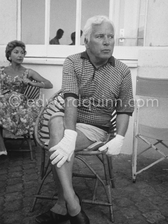 Charlie Chaplin at the Villa Lo Scoglietto. He was in Cannes to talk to the press about his latest film, "A King in New York", due to be premiered in London. When asked why he was wearing white gloves, he said it wasn\'t coquetry, but a slight case of eczema. Villa Lo Scoglietto, Saint-Jean-Cap-Ferrat, 1956. - Photo by Edward Quinn