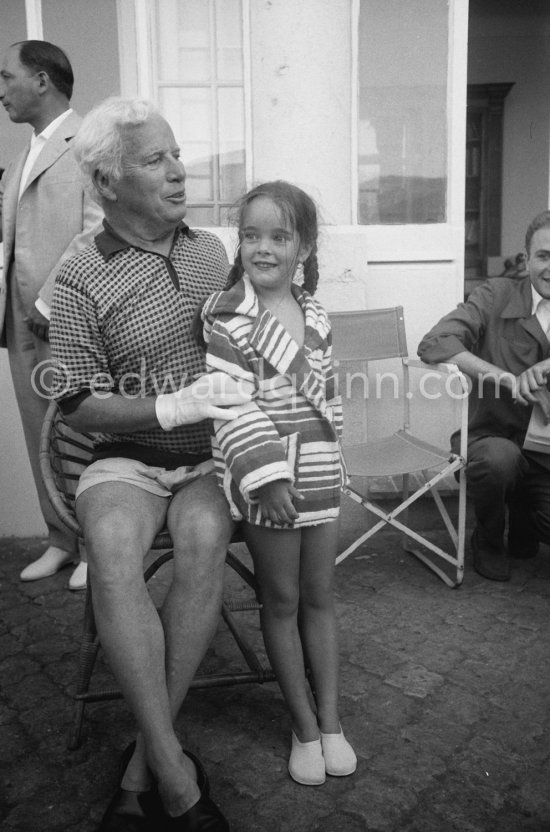 Charlie Chaplin with his daughter Victoria. Chaplin was in Cannes to talk to the press about his latest film, "A King in New York", due to be premiered in London. When asked why he was wearing white gloves, he said it wasn\'t coquetry, but a slight case of eczema. Villa Lo Scoglietto, Saint-Jean-Cap-Ferrat, 1956. - Photo by Edward Quinn