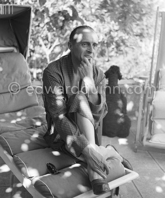 René Clair with his poodle on the terrace of his mansion. Sainte-Maxime 1953. - Photo by Edward Quinn