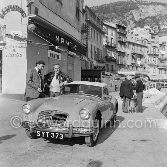 Jean Cocteau and a neighbour with his (?) MG A. Villefranche-sur-Mer 1956. - Photo by Edward Quinn