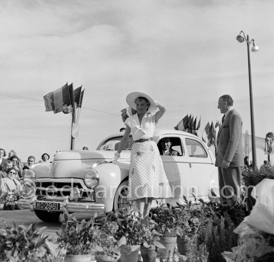 Concours d’Elégance Automobile. N° 65 Peugeot 203 of Mr. Orelli won Grand Prix, with Mrs. Paule Marchand who won Prix d\'Honneur for élégance". 
Cannes 1951. - Photo by Edward Quinn