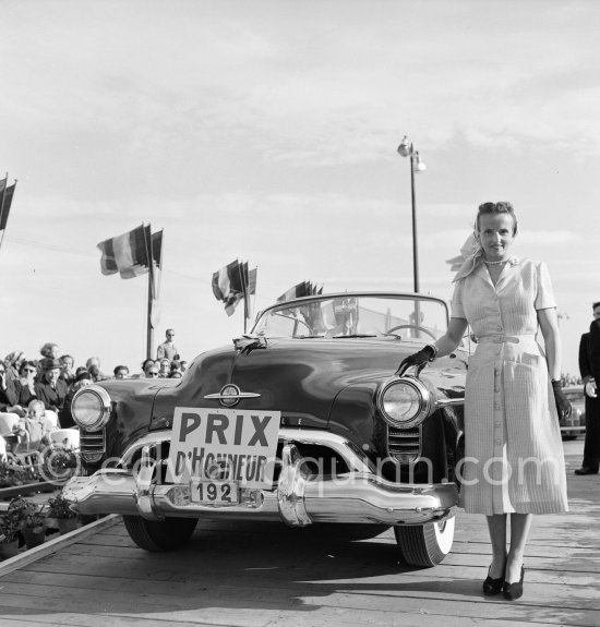 Concours d’Elégance Automobile. Oldsmobile Rackett 98 convertible of Mr. Mourlon-Beernaert won Prix d\'honneur and also "Prix de la plus belle toilette d\'après midi" (the most beautiful afternoon dress). Cannes 28.3.1951. - Photo by Edward Quinn