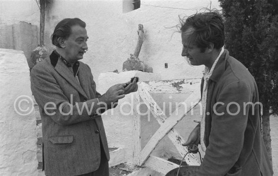 Salador Salvador Dalí and a not yet identified young man with sea urchins Salvador Dalí used for his painting work. Portlligat, Cadaqués,1957. - Photo by Edward Quinn