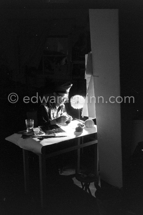 Salvador Dalí works on his experiments with the sea urchin holding a swan feather and moving backwards and forewards thus marking the blackened paper. These experiments he is carrying out at his studio in his Spanish home at Portlligat, Cadaqués, on the Costa Brava 1957. - Photo by Edward Quinn