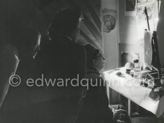 Salvador Dalí, his wife Gala and a Canadian painter friend Philipps watch fascinated as the "oursin" draws the paper, this time with a light dried up flower. At Dalí\'s house, Portlligat, Cadaqués 1975 - Photo by Edward Quinn