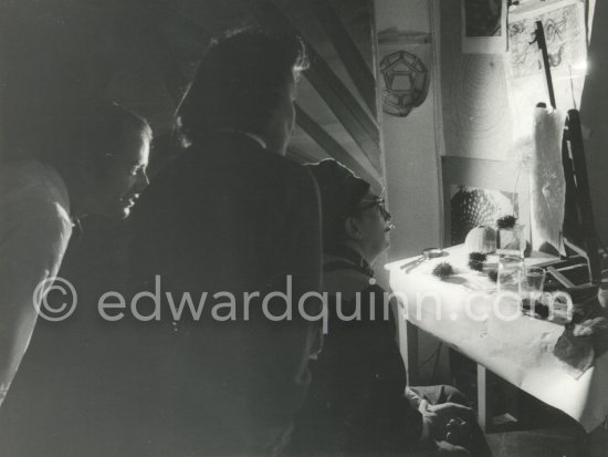 Salvador Dalí, his wife Gala and a Canadian painter friend Philipps watch fascinated as the "oursin" draws the paper, this time with a light dried up flower. At Dalí\'s house, Portlligat, Cadaqués 1975 - Photo by Edward Quinn