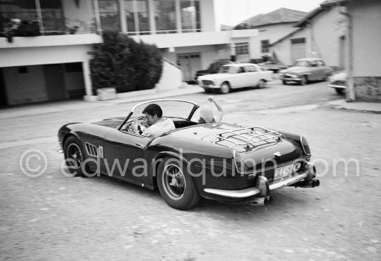 Alain Delon and Jane Fonda arriving at the film set of "Les Félins" ("Love Cage"). Ferrari 250 GT Spider California 1961. Antibes 1964. This car of Alain Delon was hammered 2015 for a record-breaking $18.5 million at an auction at Artcurial in Paris. The 250 GT Spyder California, Chassis No 2935, had been bought new by the actor Gérard Blain, then sold to fellow actor Alain Delon, who was photographed several times at the wheel of this machine, including in 1964. One of 37 examples, this Pininfarina-designed cabriolet, its whereabouts unknown to marque historians until now, is bound to attract the attention of collectors of important historic Ferrari. - Photo by Edward Quinn