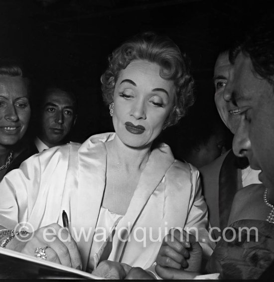 Marlene Dietrich signing autographs after her show at the club Sporting d'Eté in Monte Carlo in 1954. - Photo by Edward Quinn