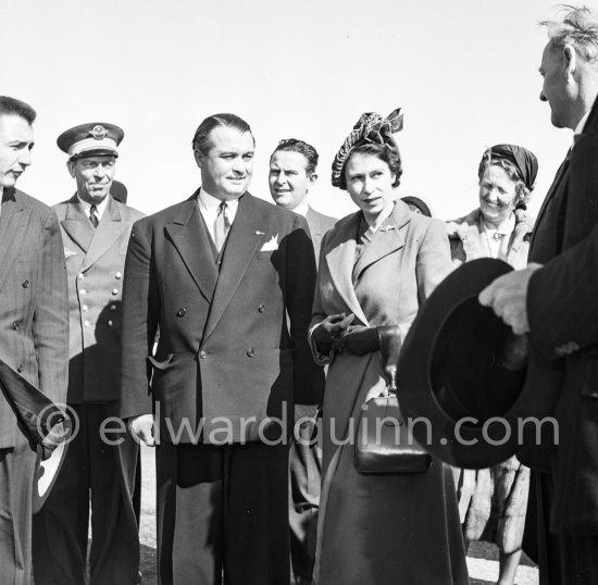 The onlookers saw Princess Elizabeth, later Queen Elizabeth II, very stylishly dressed disembarking from a Viking aircraft during the stop she made at Nice Airport, while on a flight from London to Malta where she was going to meet the Duke of Edinburgh, Prince Philip. She was greeted by local officials. Nice 19.3.1951. - Photo by Edward Quinn