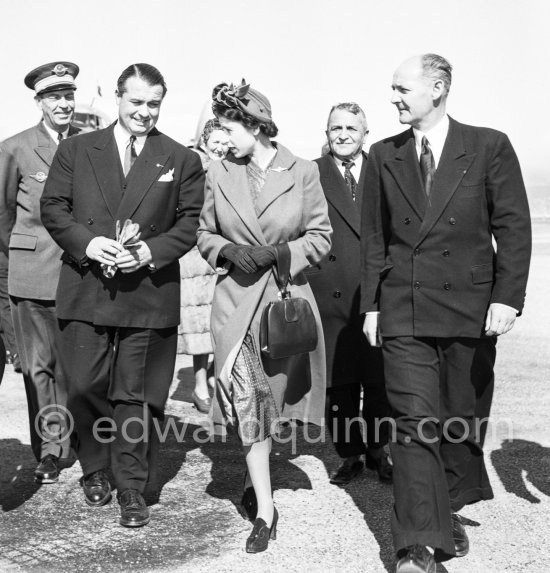 The onlookers saw Princess Elizabeth, later Queen Elizabeth II, very stylishly dressed disembarking from a Viking aircraft during the stop she made at Nice Airport, while on a flight from London to Malta where she was going to meet the Duke of Edinburgh, Prince Philip. She was greeted by local officials. Nice 19.3.1951. - Photo by Edward Quinn