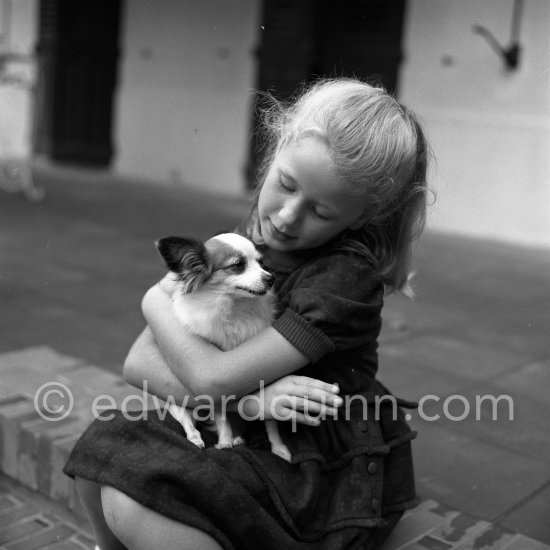 Two sweethearts, Brigitte Fossey and her Papillon. Brigitte became famous as a six year-old with the film Jeux interdits (Forbidden Games). Cannes 1953. - Photo by Edward Quinn