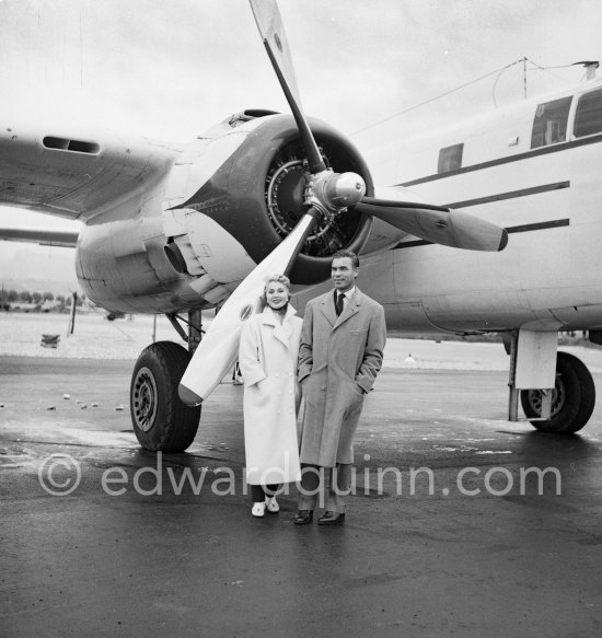 Zsa Zsa Gabor and Porfirio Rubirosa in front of the private plane of Porfirio Rubirosa, a converted North American B-25 Mitchell, at Cannes Airport in 1954. North American B-25 Mitchell B-25H-1NA 43-4432 (N10V). See https://bit.ly/2XS08rs. Was as "Berlin Express" in the 1970 movie Catch-22. Today at Eagle Hangar, EAA Aviation Museum, Oshkosh. - Photo by Edward Quinn