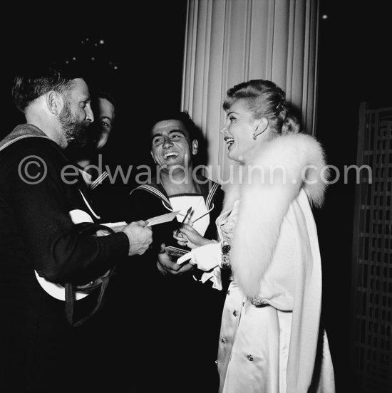 Hungarian actress Zsa Zsa Gabor signing autographs for the British Navy at the Cannes Festival in 1955. - Photo by Edward Quinn