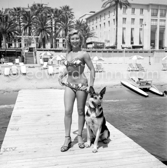 Beauty Queen Colette Gosse, "Miss Palm Beach 1950," and her proud German Shepherd Dog. Cannes 1951. - Photo by Edward Quinn