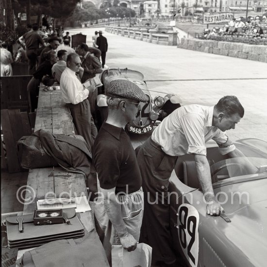 Tom Wisdom, (82) Jaguar C-Type. Person with checkered hat not yet identified. Behind the Jaguar Delahaye 135S of Cotton, (62). This C-type is famous for the journey it made in 1952 - from Coventry to the Monaco Grand Prix - where it finished 6th and was the first non-Ferrari. The car was driven by Tommy Wisdom in that race – and then driven back to the UK! Monaco Grand Prix 1952, transformed into a race for sports cars. This was a two day event, the Sunday for the up to 2 litres (Prix de Monte Carlo), the Monday for the bigger engines, (Monaco Grand Prix). - Photo by Edward Quinn