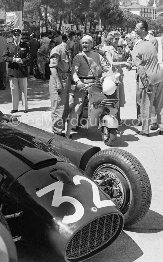 Louis Chiron, (32) Lancia D50, on his Vespa. Monaco Grand Prix 1955. - Photo by Edward Quinn