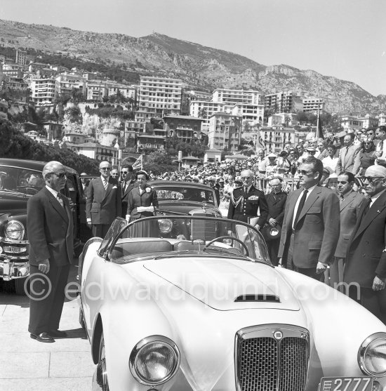 During the national anthem: Rainier III, Prince of Monaco before his parade lap before the start of the Monaco Grand Prix 1955. On the left in the backround Prince Rainier\'s father Prince Pierre and Princess Antoinette , behind Rainier Father Tucker. Cars: Lancia Aurelia B24 Spider America Cabriolet 1955, Mercedes-Benz 300c W186 ("Adenauer-Mercedes") - Photo by Edward Quinn