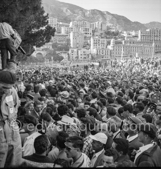 Somewhere in the crowd completely surrounded French driver Maurice Trintignant, winner of the Monaco Grand Prix 1955. - Photo by Edward Quinn