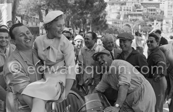 Bella Darvi, who had a leading role in the film "The Racers", supposed to be a flirt of Prince Rainier, and mechanics of the Maserati Racing Team. Monaco Grand Prix 1955. - Photo by Edward Quinn