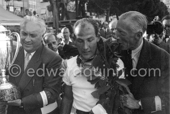 The winner: Stirling Moss on Maserati 250F with two commissaires sportives. Monaco Grand Prix 1956. - Photo by Edward Quinn