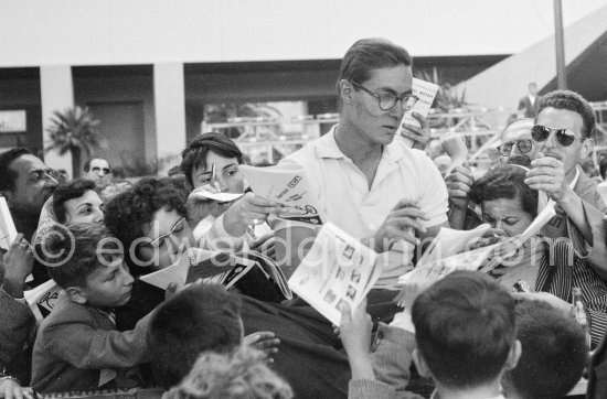 Masten Gregory, (2) Maserati 250F, signing autographs. Monaco Grand Prix 1955. - Photo by Edward Quinn