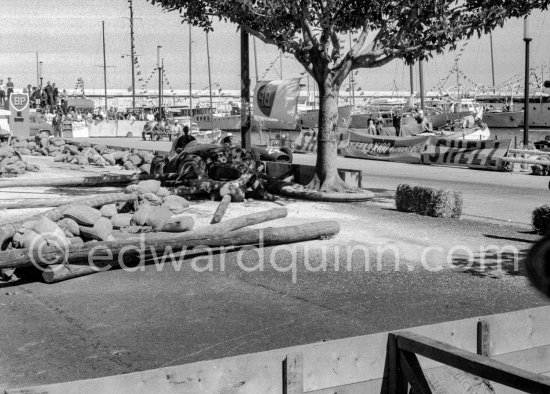 The wreck of Moss' (18) Vanwall VW3/4 in the barriers. In the background Wolfgang von Trips, (24) Ferrari 80I, passes. Monaco Grand Prix 1957. The incident happend in lap 4 of the 1957 Monaco Grand Prix after leader Stirling Moss "lost" his Vanwall in the chicane. - Photo by Edward Quinn