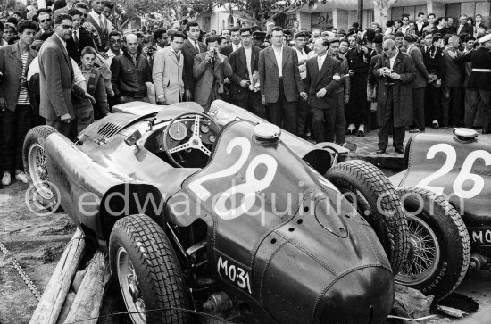 After the race: The cars of Mike Hawthorn, (28) Ferrari-Lancia D50 and Peter Collins, (26) Ferrari 801 in the barriers while Wolfgang von Trips, (24) Ferrari 80I, passes. The incident happend in lap 4 of the 1957 Monaco Grand Prix after leader Stirling Moss "lost" his Vanwall in the chicane. Peter Collins swerved to avoid Moss but hit the wall while Mike Hawthorn rammed Tony Brooks who braked hard to avoid the cars in front of him. - Photo by Edward Quinn