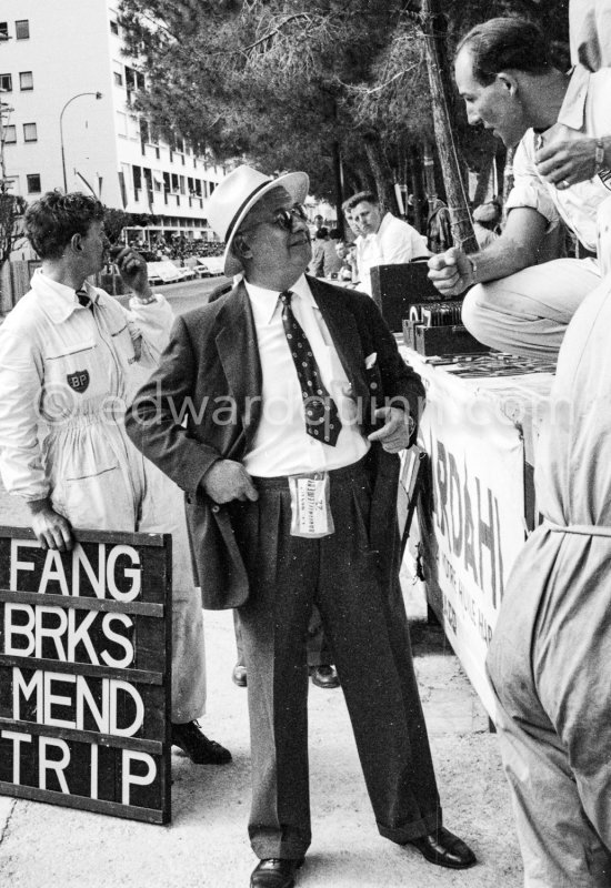 Stirling Moss and Tony Vandervell, head of the Vanwall Formula One racing team. A mechanic with a pit board. Monaco Grand Prix 1957. - Photo by Edward Quinn