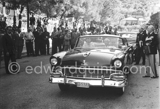 Prince Rainier of Monaco driving the official car (Ford Fairlane Sunliner 1956) with Princess Grace prior to the Monaco Grand Prix 1957. - Photo by Edward Quinn
