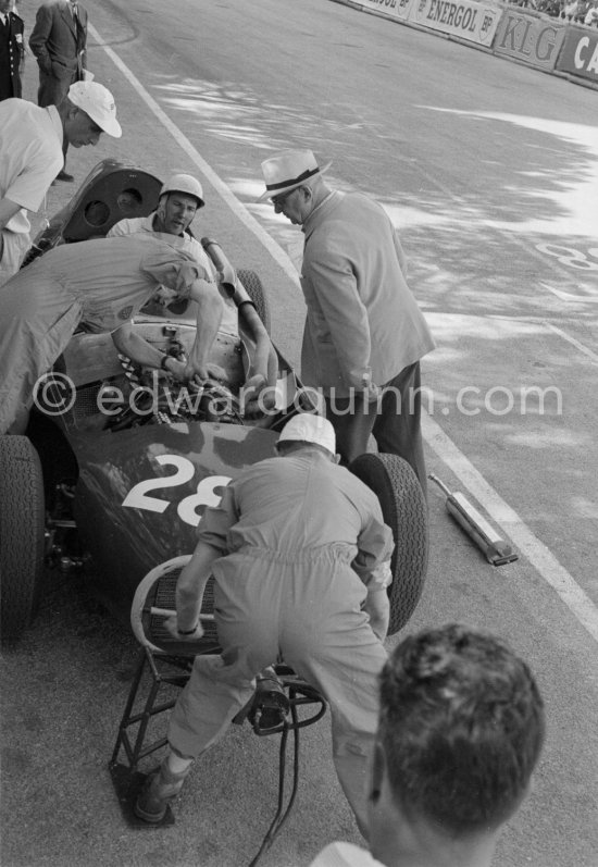 Stirling Moss, (28) Vanwall VW7, stops at the pits with valve problems. Tony Vandervell (white hat), founder of the Vanwall Formula One racing team. Monaco Grand Prix 1958. - Photo by Edward Quinn